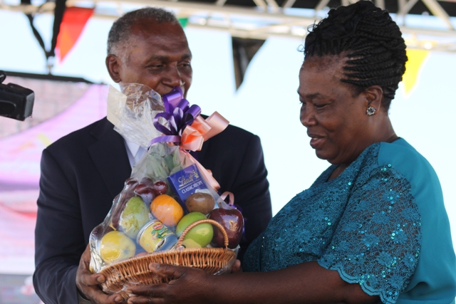 Premier of Nevis Hon. Vance Amory presents a plaque to Ms. Tyzena Brookes, Paton of the 23 Annual Department of Agriculture Open Day in recognition of 22 years of dedicated service to the department at the opening ceremony at the Villa Grounds in Charlestown on March 30, 2017